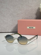 MiuMiu round sunglasses with silver-tone frame and green-tinted lenses