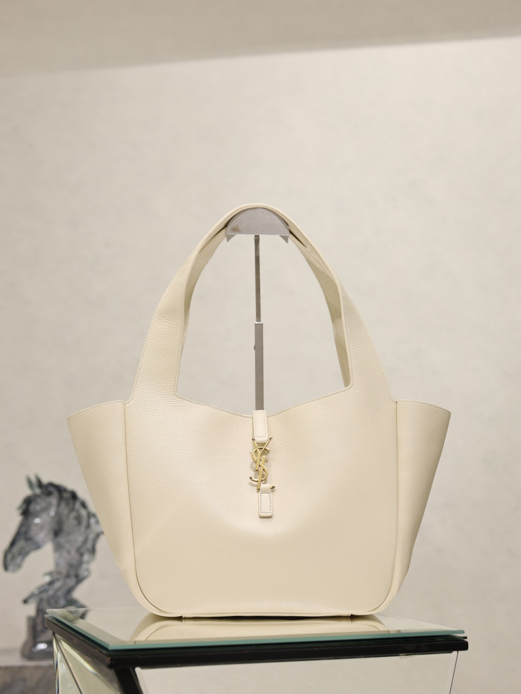 YSL cream tote bag with top handles and gold emblem clasp