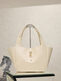YSL cream tote bag with top handles and gold emblem clasp