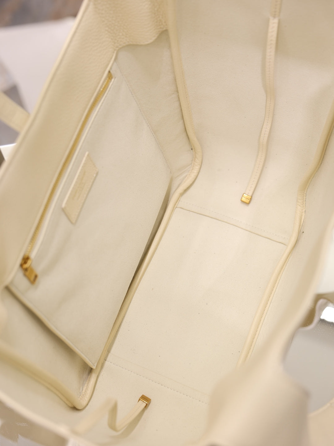 YSL cream tote bag interior pocket with gold pull and stitched paneling