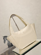 YSL cream tote bag with open top and gold emblem clasp