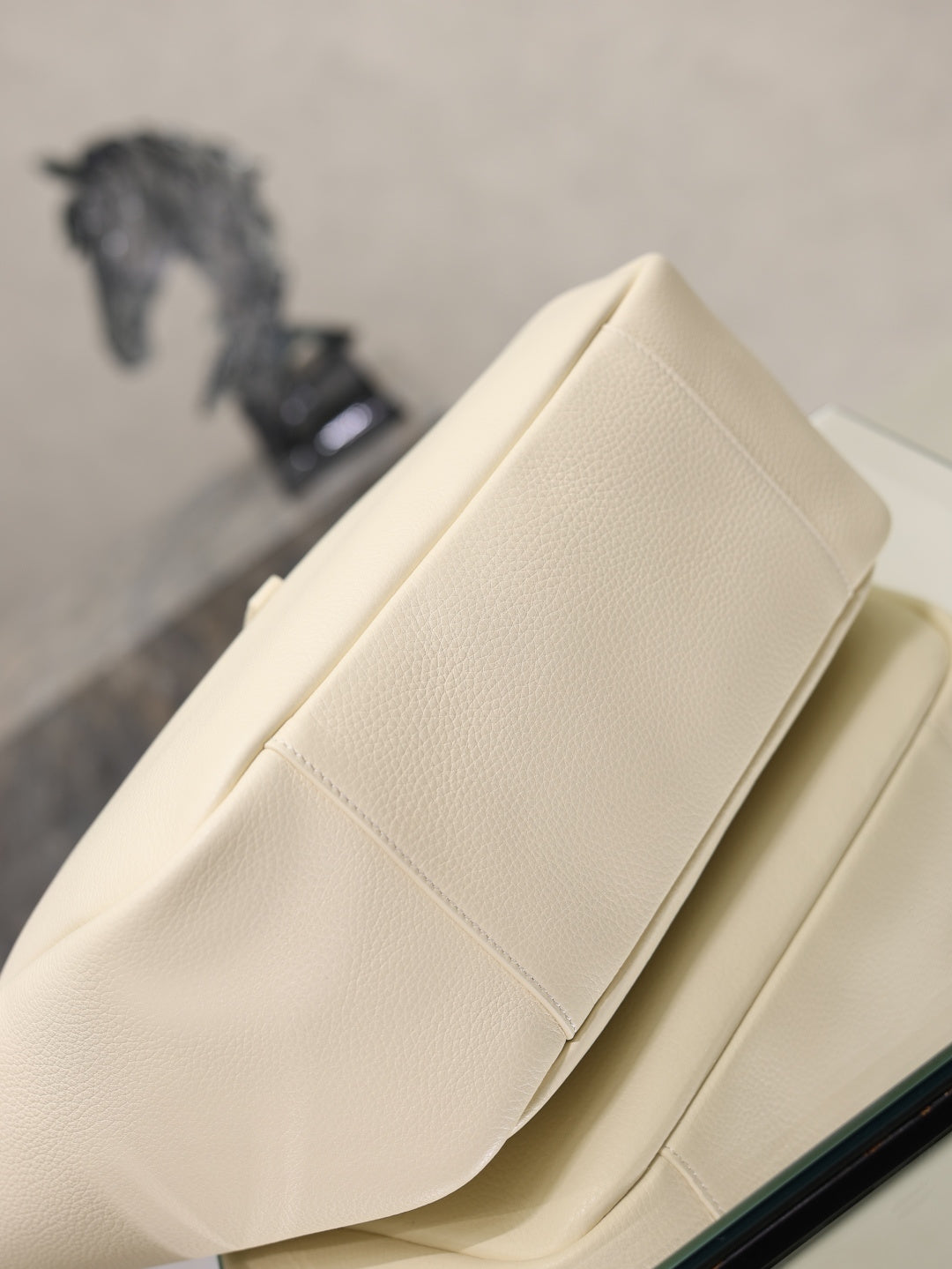 YSL cream leather tote bag with slim side profile and stitched panel detail