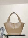 Beige leather YSL tote bag with top handles and gold logo detail at center front