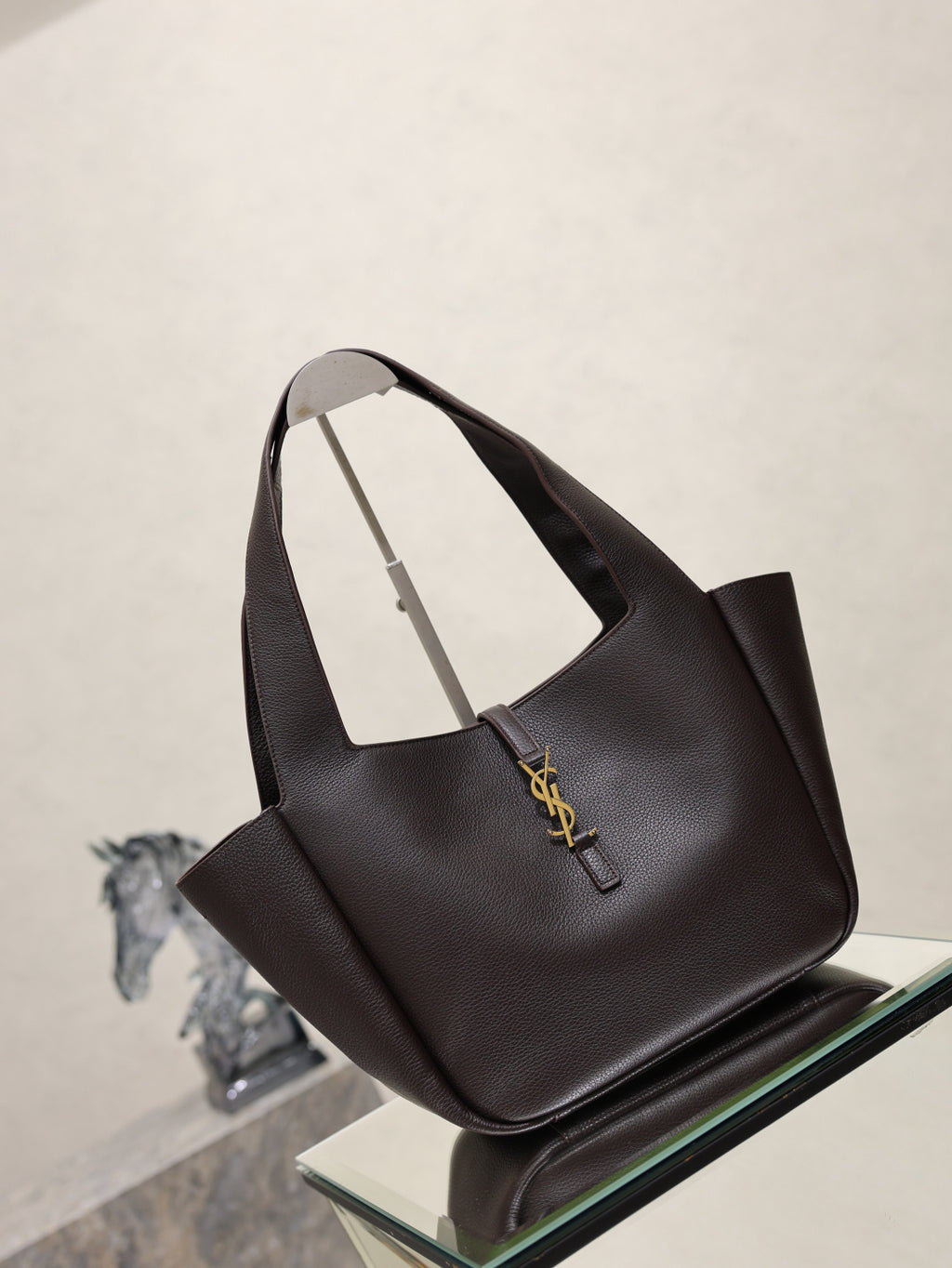 YSL bag tote in dark pebbled leather with front logo charm and curved handles