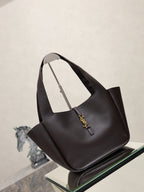 YSL bag tote in dark pebbled leather with front logo charm and curved handles