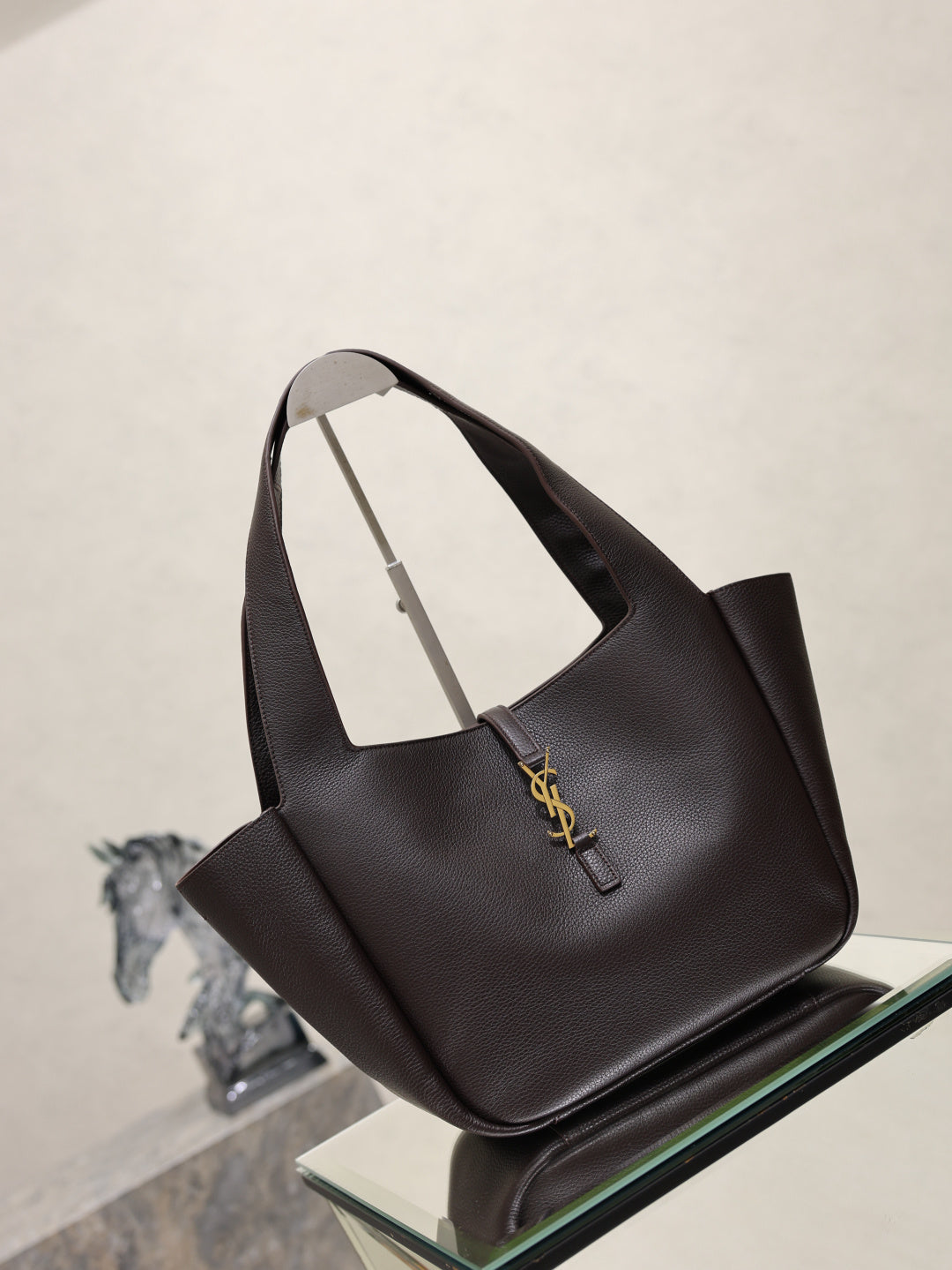 YSL bag tote in dark pebbled leather with front logo charm and curved handles