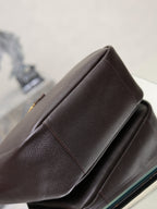 YSL bag side seam detail in dark pebbled leather with structured edge