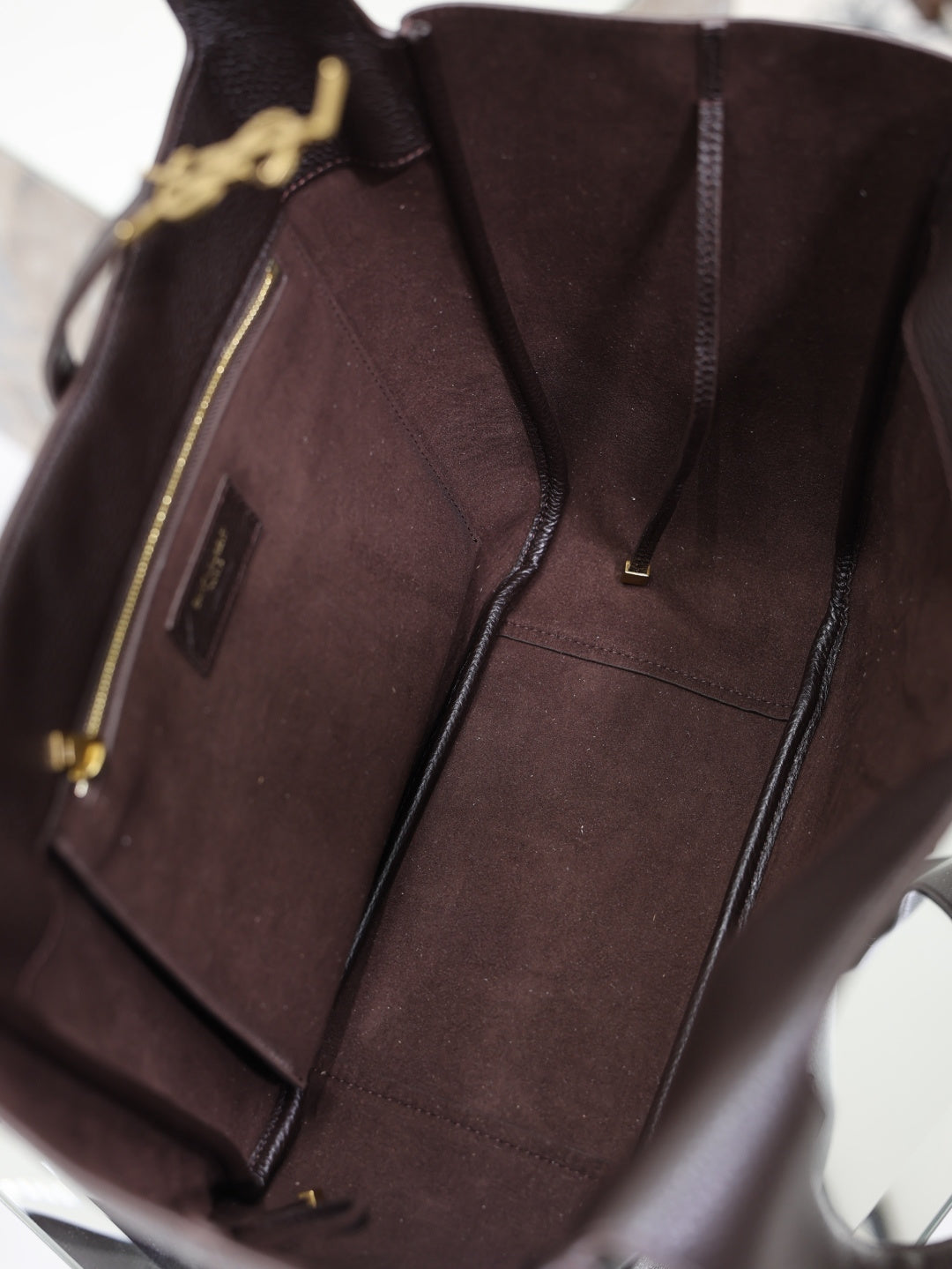 YSL bag interior with brown lining and zip pocket shown at open top