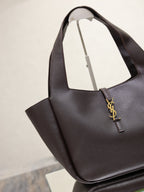 YSL bag tote with dark pebbled leather, gold YSL logo charm, and open top