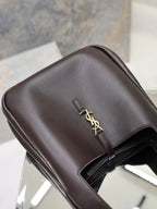 YSL bag top flap view in dark pebbled leather with gold YSL clasp