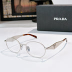 Prada eyeglasses with silver metal round frames, tortoise temple tips, clear lenses