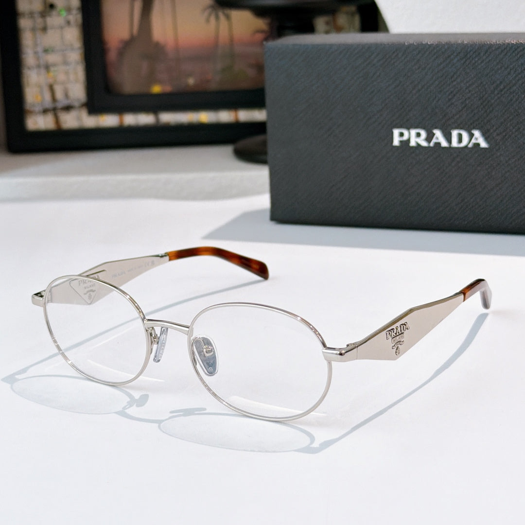 Prada eyeglasses with silver metal round frames, tortoise temple tips, clear lenses