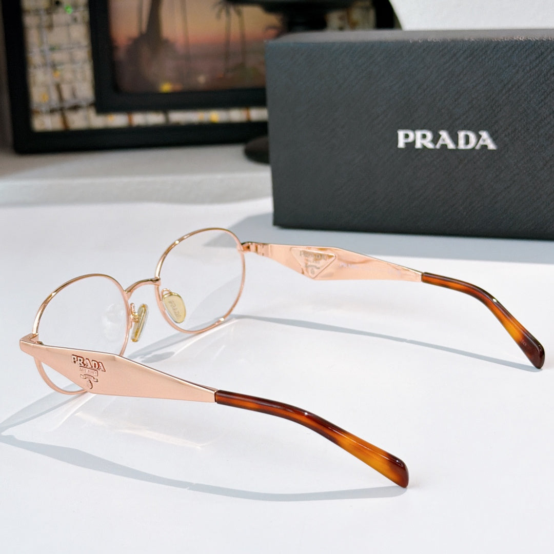 Prada eyeglasses with rose-gold round frames, clear lenses, tortoise brow tips