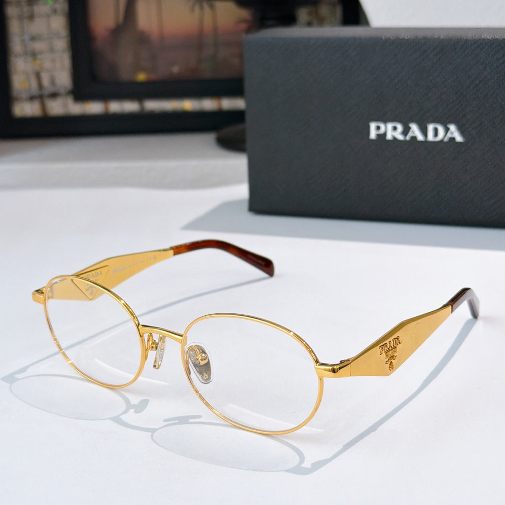 Prada eyeglasses with gold metal round frames and clear lenses