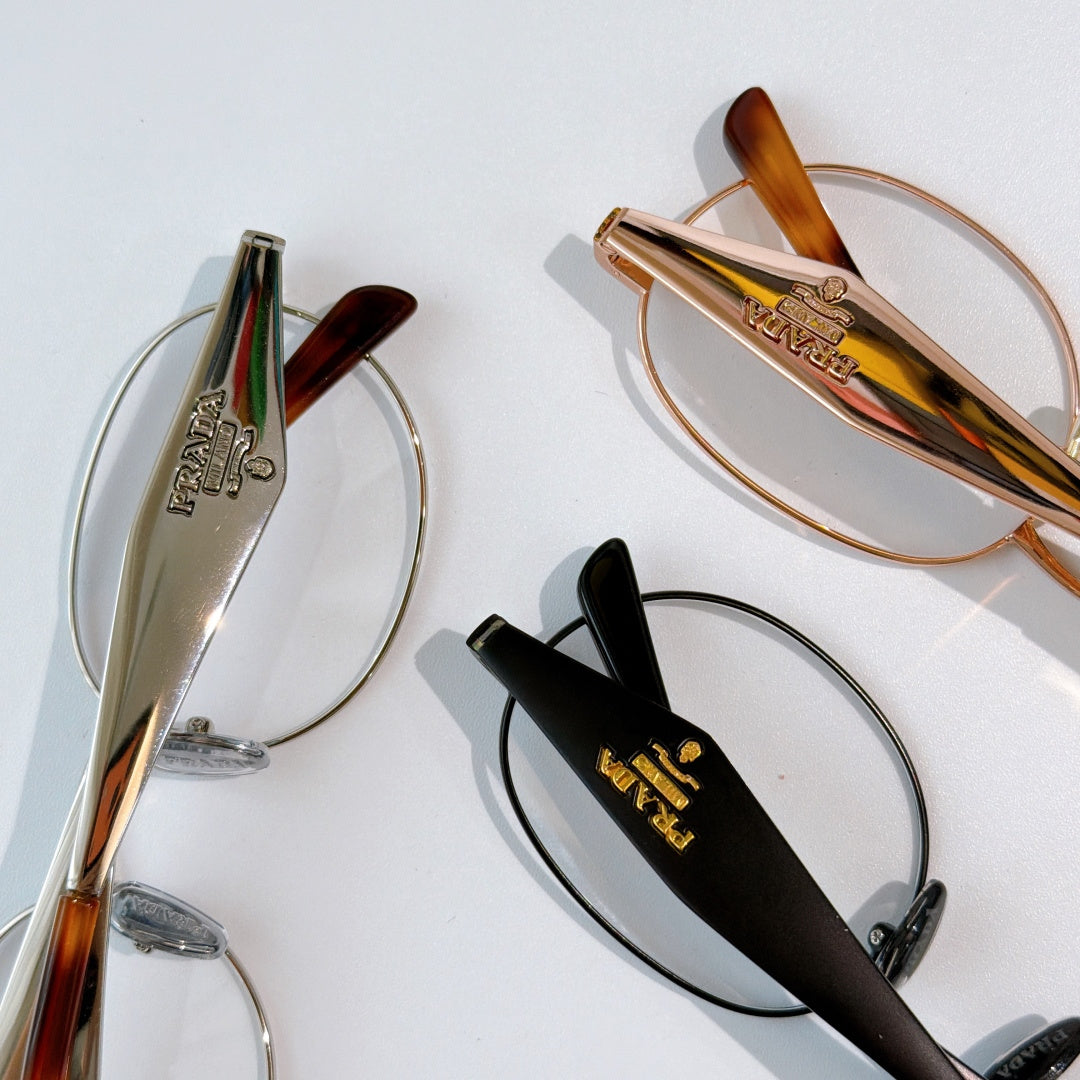 Prada eyeglasses side frames with metal and dark temple arms, clear lenses