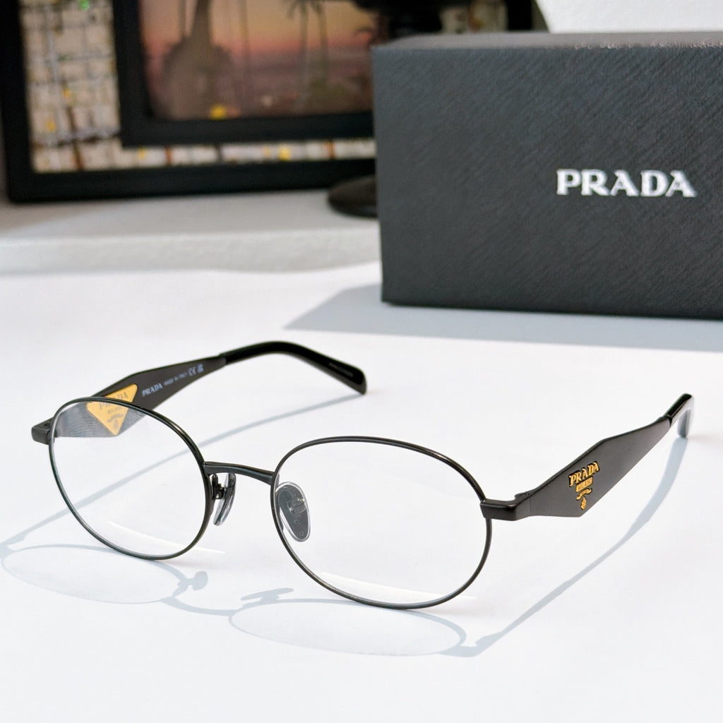 Prada eyeglasses with dark round frames, clear lenses, gold logo temple details