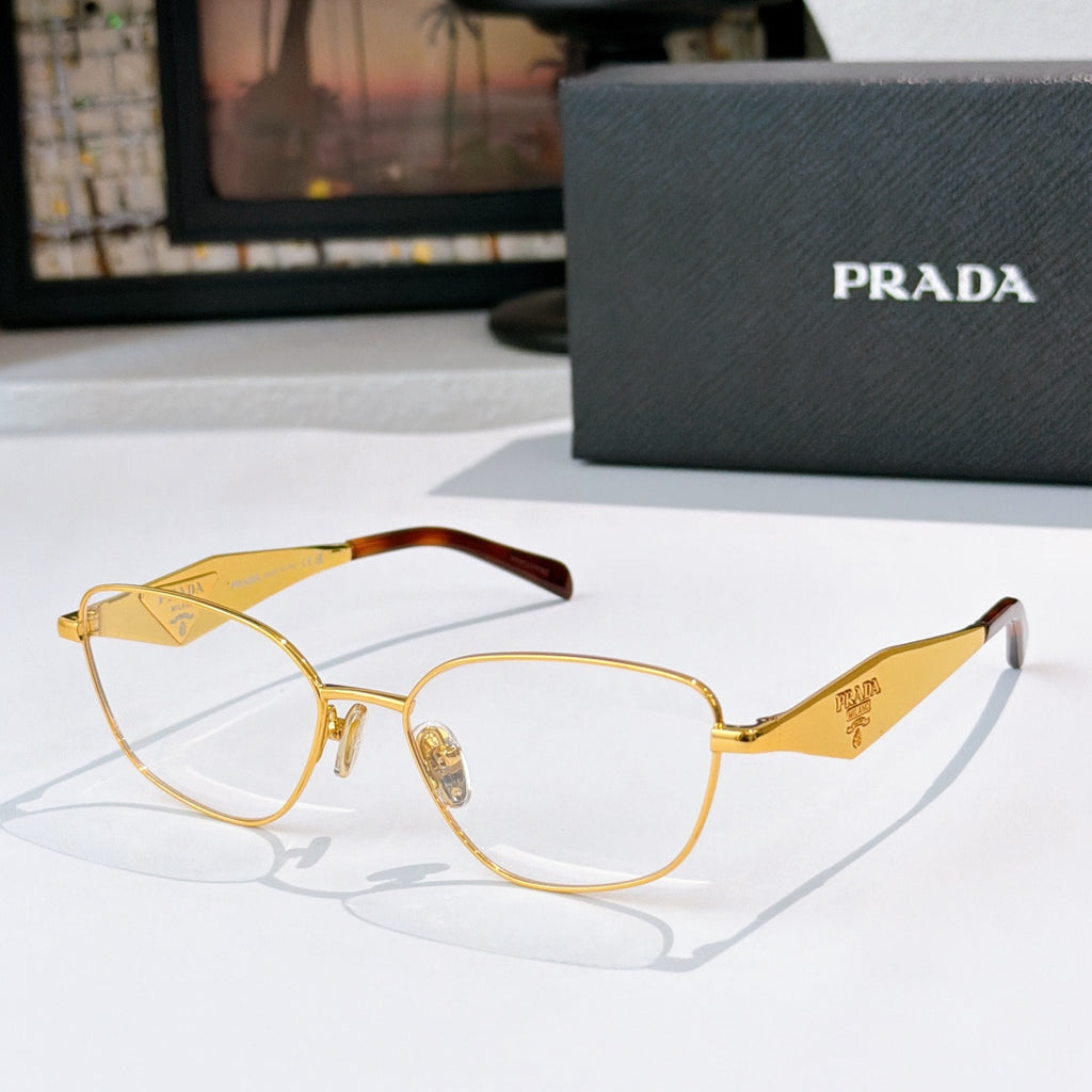 Prada eyeglasses with gold round frames and clear lenses, logo temple tips.