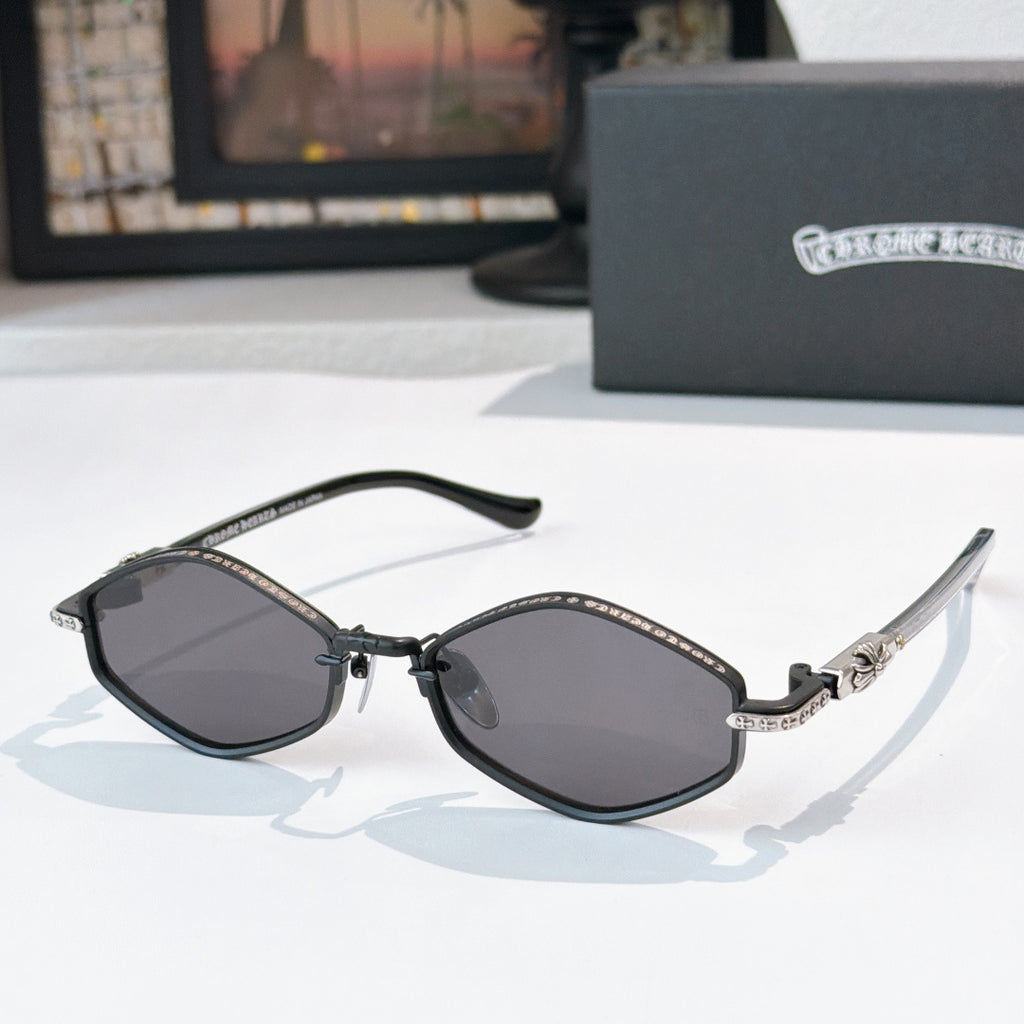 Chrome sunglasses with dark lenses, black metal frame, and patterned bridge detail.