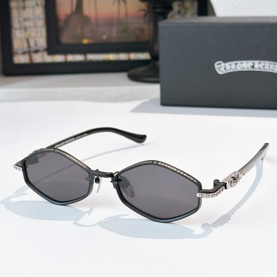 Chrome sunglasses with dark lenses, black metal frame, and patterned bridge detail.