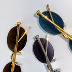 Cartier sunglasses with gold and silver round frames and blue and dark tinted lenses