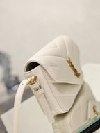 Cream YSL flap bag with strap and gold hardware, shown from rear angle