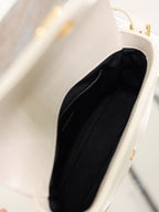 Cream YSL bag interior with black lining and open top