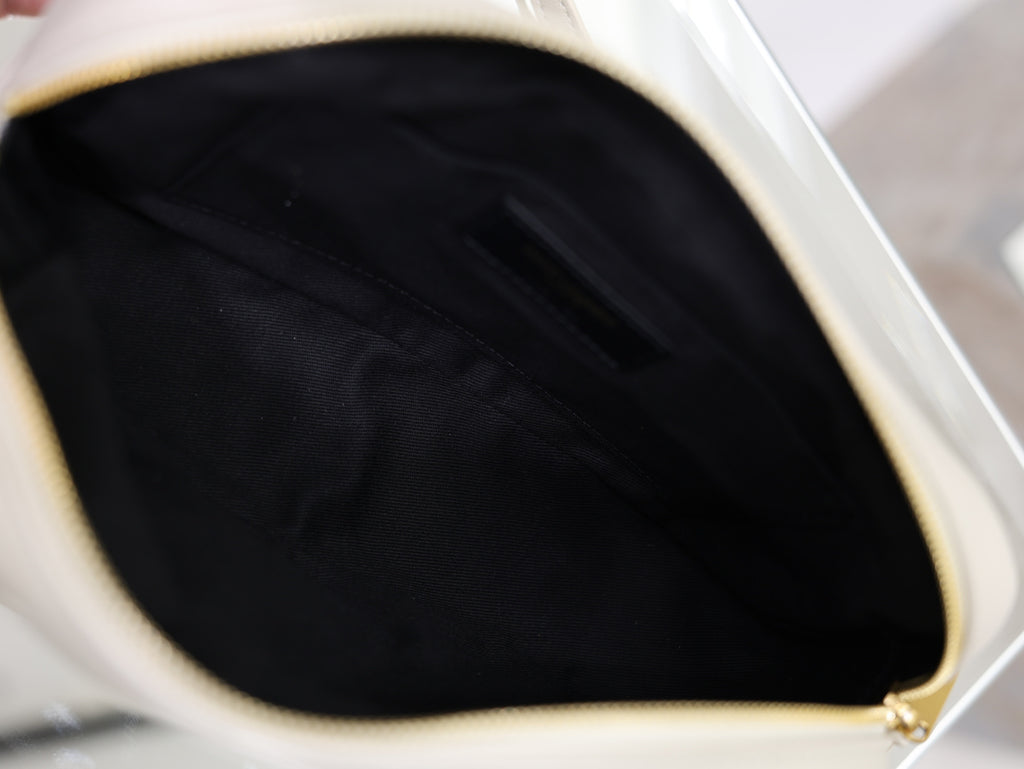 YSL bag interior with black fabric lining and gold zipper trim