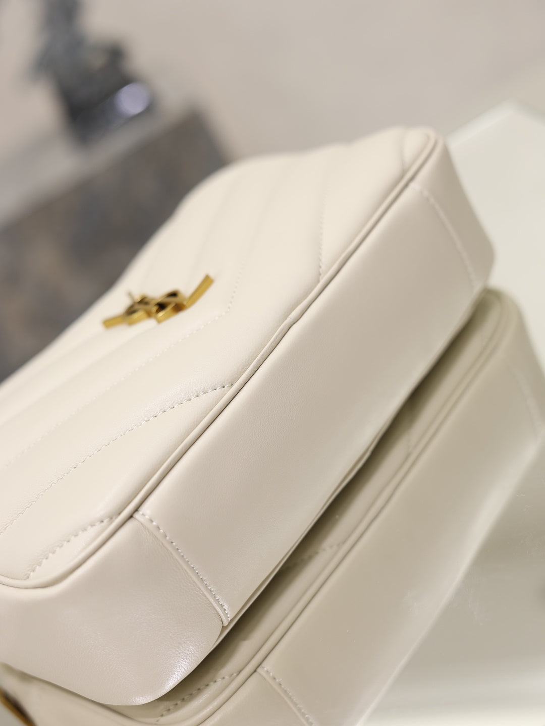 YSL cream quilted bag back with gold logo hardware and stitched panels