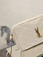 YSL cream quilted bag close-up with gold chain strap and logo front detail