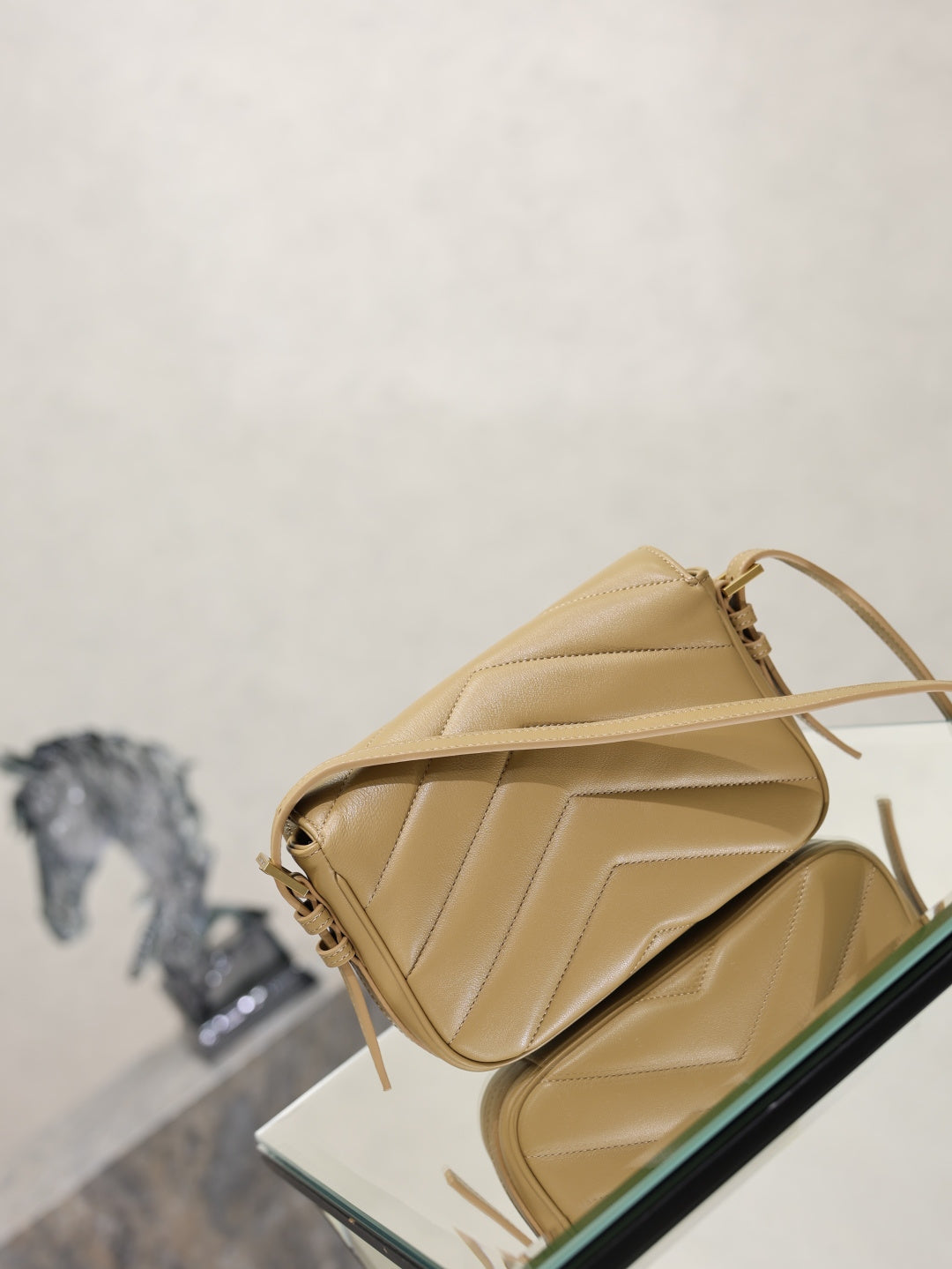 YSL quilted beige crossbody bag top view with flap and adjustable shoulder strap