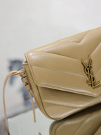 YSL beige quilted crossbody bag close-up with flap, YSL logo, and gold hardware