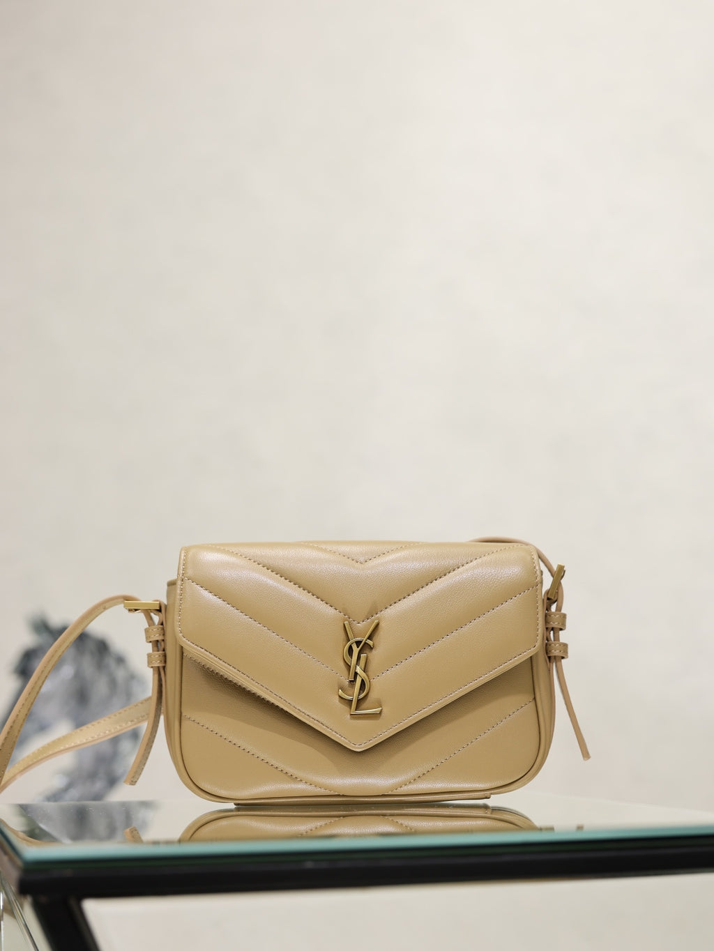 YSL quilted beige crossbody bag with flap, YSL logo, and gold hardware