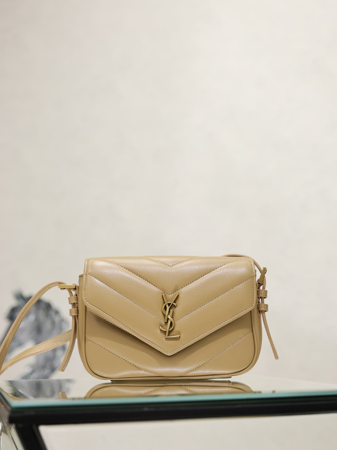 YSL quilted beige crossbody bag with flap, YSL logo, and gold hardware