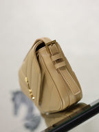 YSL beige quilted crossbody bag side view with stitched panels and gold hardware