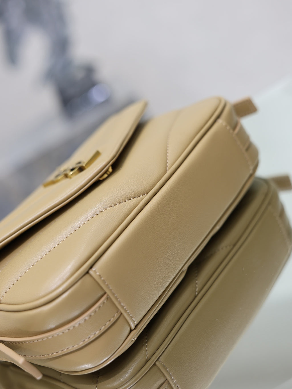 YSL beige quilted crossbody bag close-up of side stitching and flap seam detail