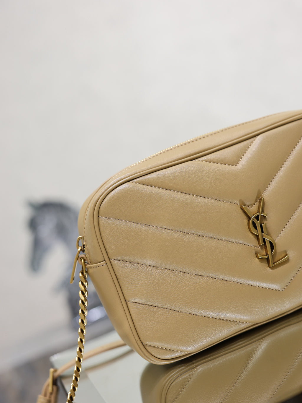 Quilted leather crossbody bag with YSL logo hardware and chain strap, light tan