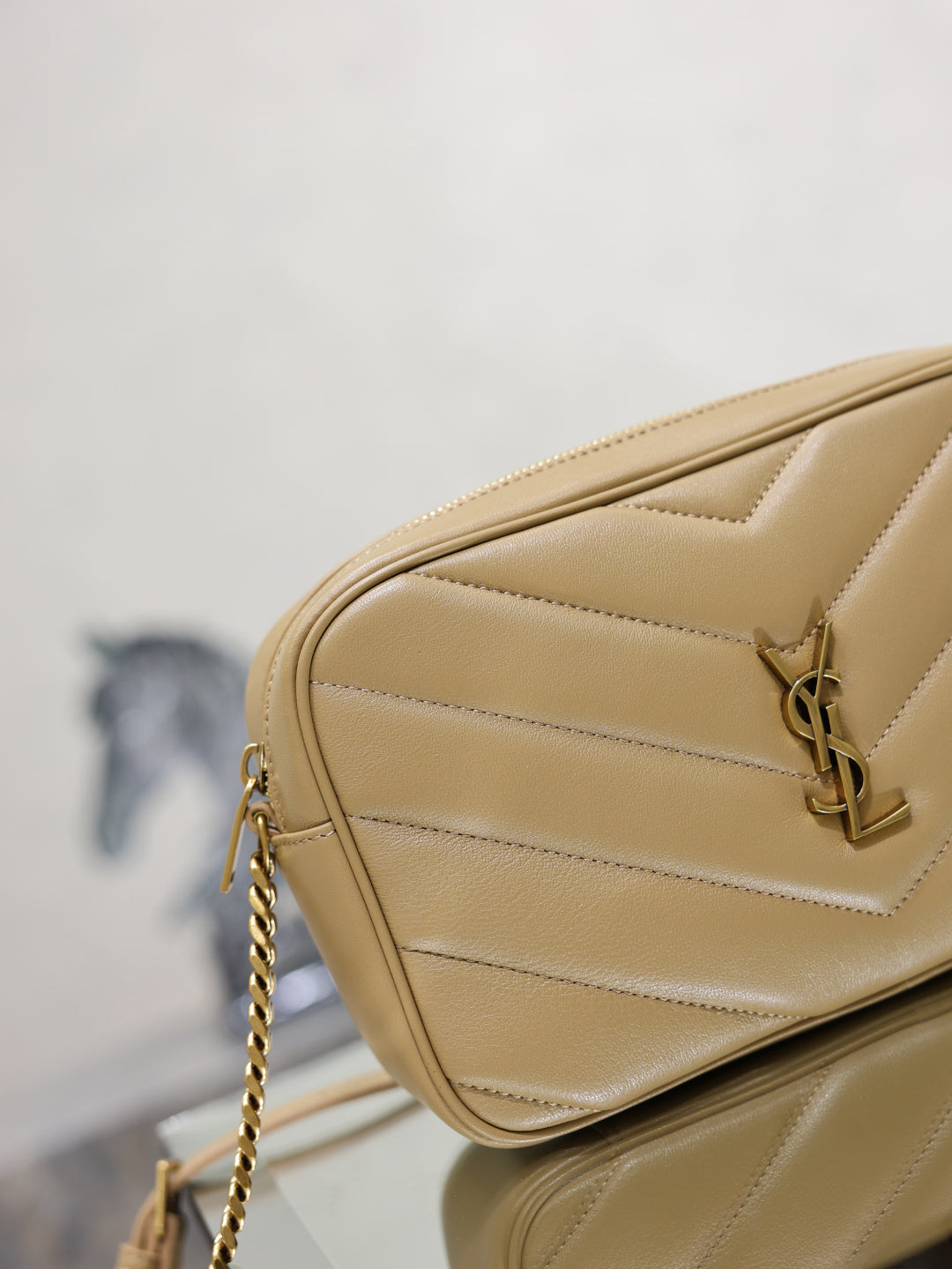 Quilted leather crossbody bag with YSL logo hardware and chain strap, light tan