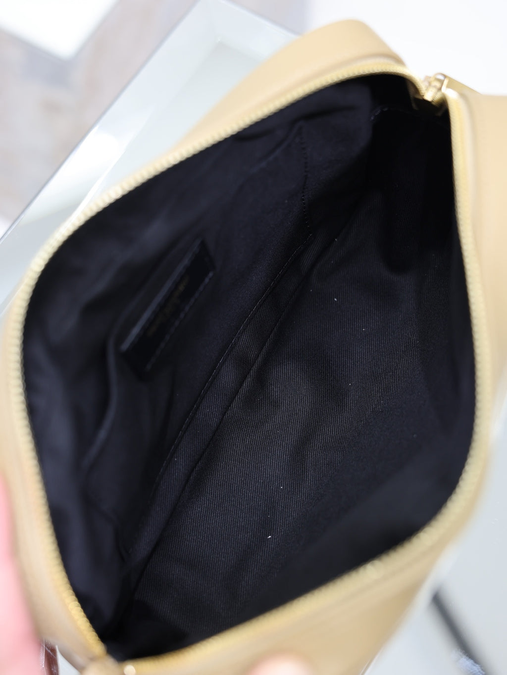 Open quilted leather shoulder bag with dark fabric lining, gold trim, light tan