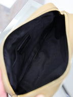 Open quilted leather shoulder bag with dark fabric lining, gold trim, light tan