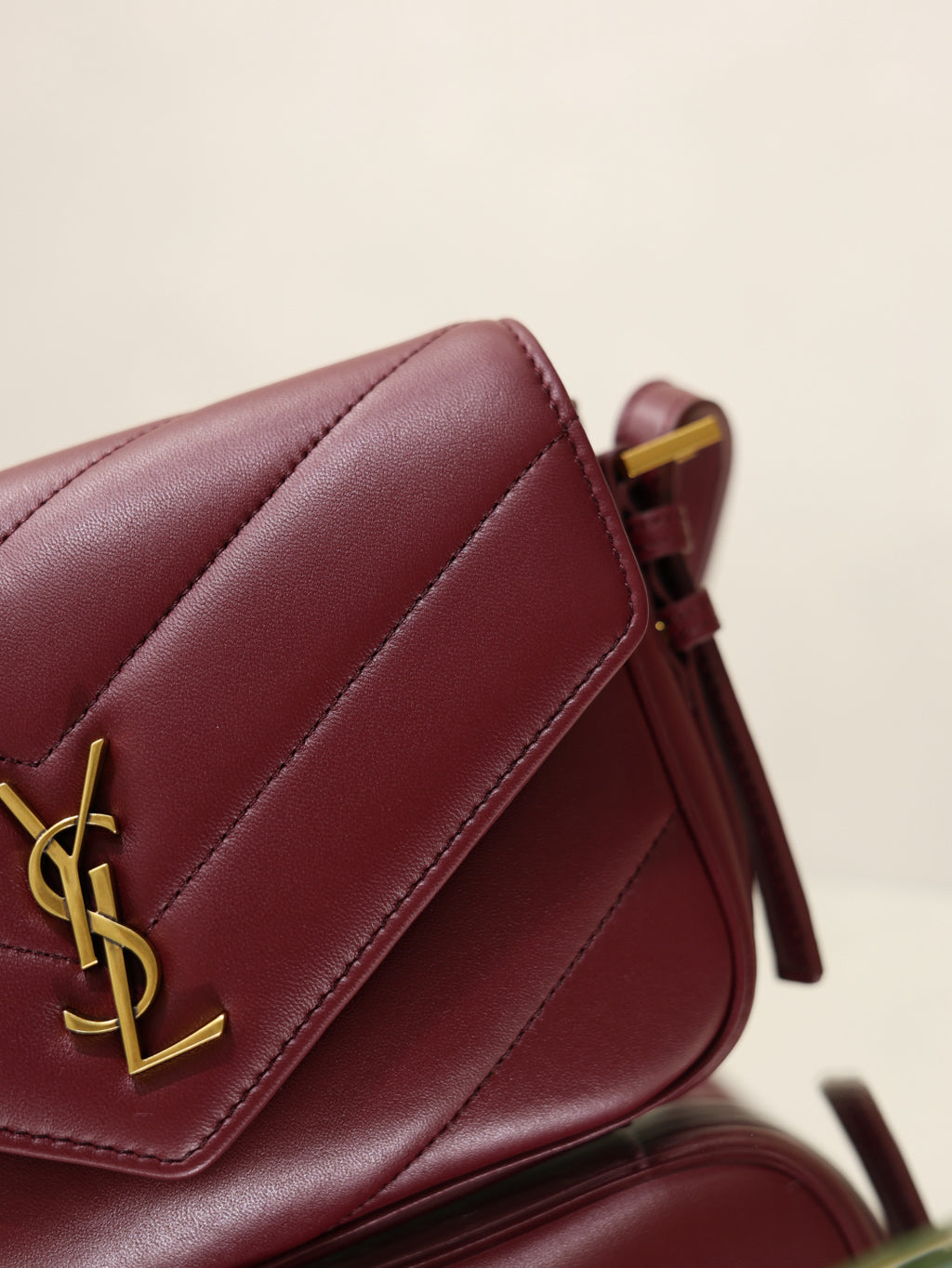 YSL quilted leather bag in burgundy, front flap with YSL monogram and gold hardware