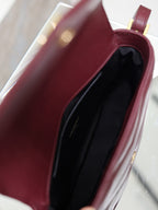 YSL quilted leather bag with burgundy interior lining, open top view