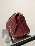 YSL quilted leather bag in burgundy, back view with gold hardware and strap
