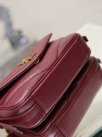 YSL quilted leather bag in burgundy, stitched side detail with strap hardware