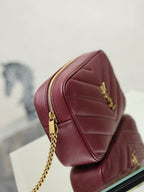 YSL bag back view in burgundy with gold chain strap and vertical stitched panels