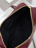 YSL bag open top showing black interior lining with gold-trimmed zipper