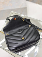 Black quilted shoulder bag on display with gold hardware and flap closure