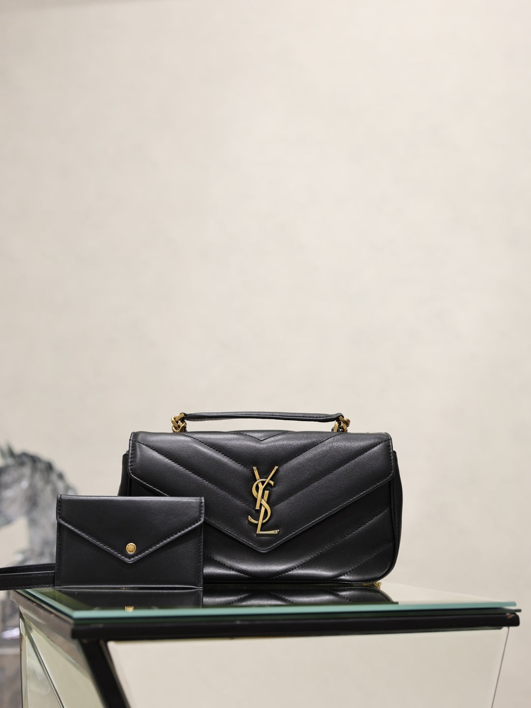 Black quilted shoulder bag with YSL logo and small matching card holder