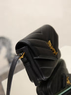 Black YSL mini bag with quilted texture and gold hardware, side view