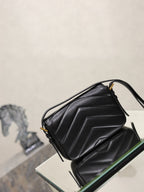 Black quilted YSL shoulder bag with top handle and side flap detail