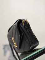 Black YSL mini bag corner view with gold YSL hardware and handle